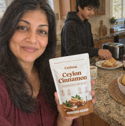 Woman at a kitchen island holding a Ceylarae pouch on a school morning