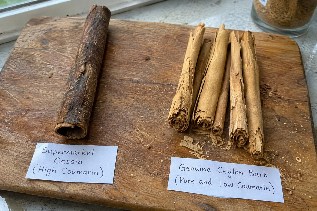 Realistic split-angle kitchen photo on a rustic wooden cutting board. Left side: a single thick, rough, dark brown Cassia stick with a small label "Supermarket Cassia (High Coumarin)"
