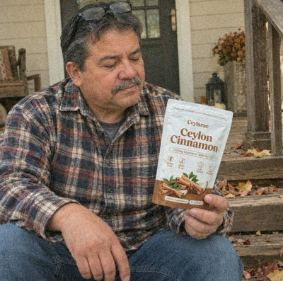 Man on porch steps holding a Ceylarae pouch on his knee