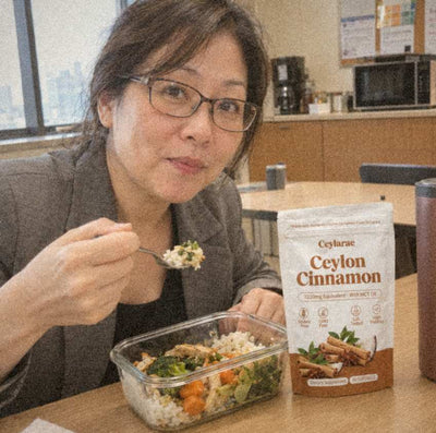 Woman at an office lunch with a Ceylarae pouch beside her lunch